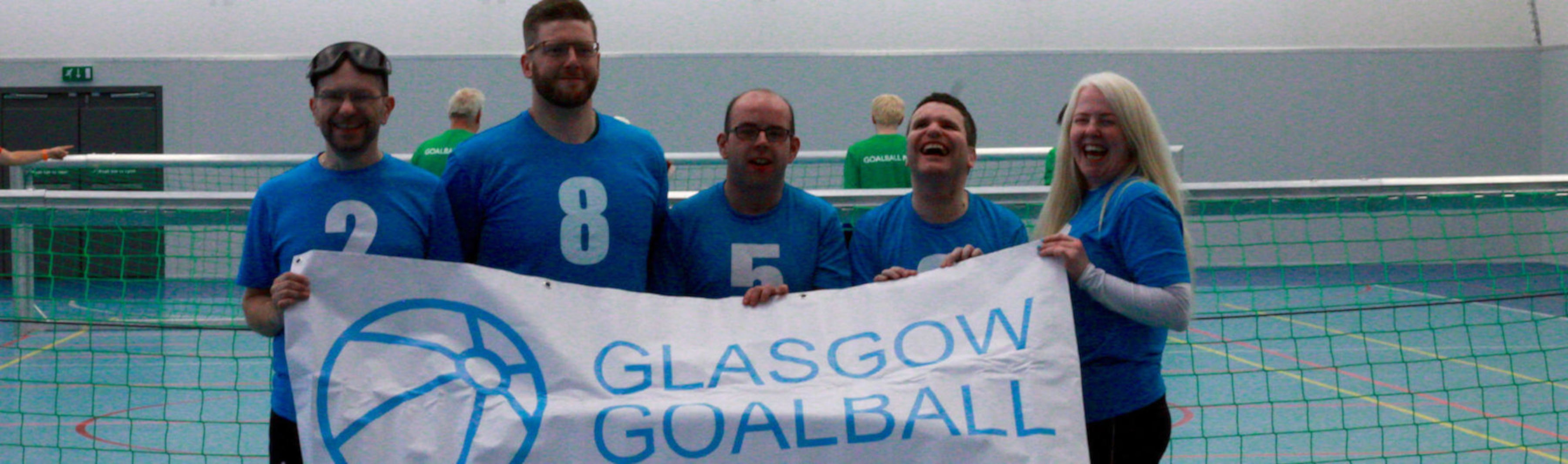 Members of the club holding a Glasgow Goalball banner